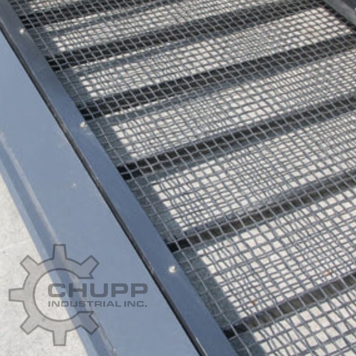 Wolverine screening bucket screen: steel mesh panel over the ribbed floor, framed by the bucket's side rail