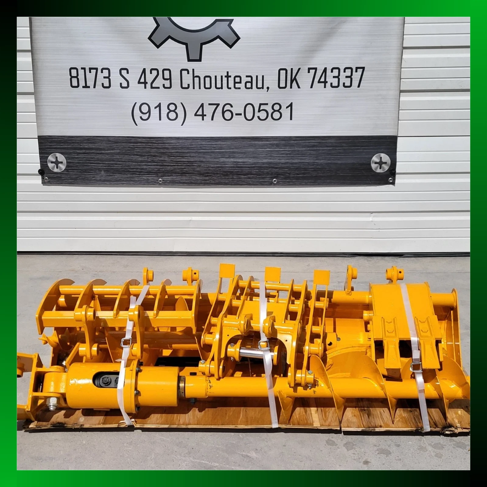 Yellow attachment package strapped to a pallet below a shop banner reading 8173 S 429 Chouteau, OK