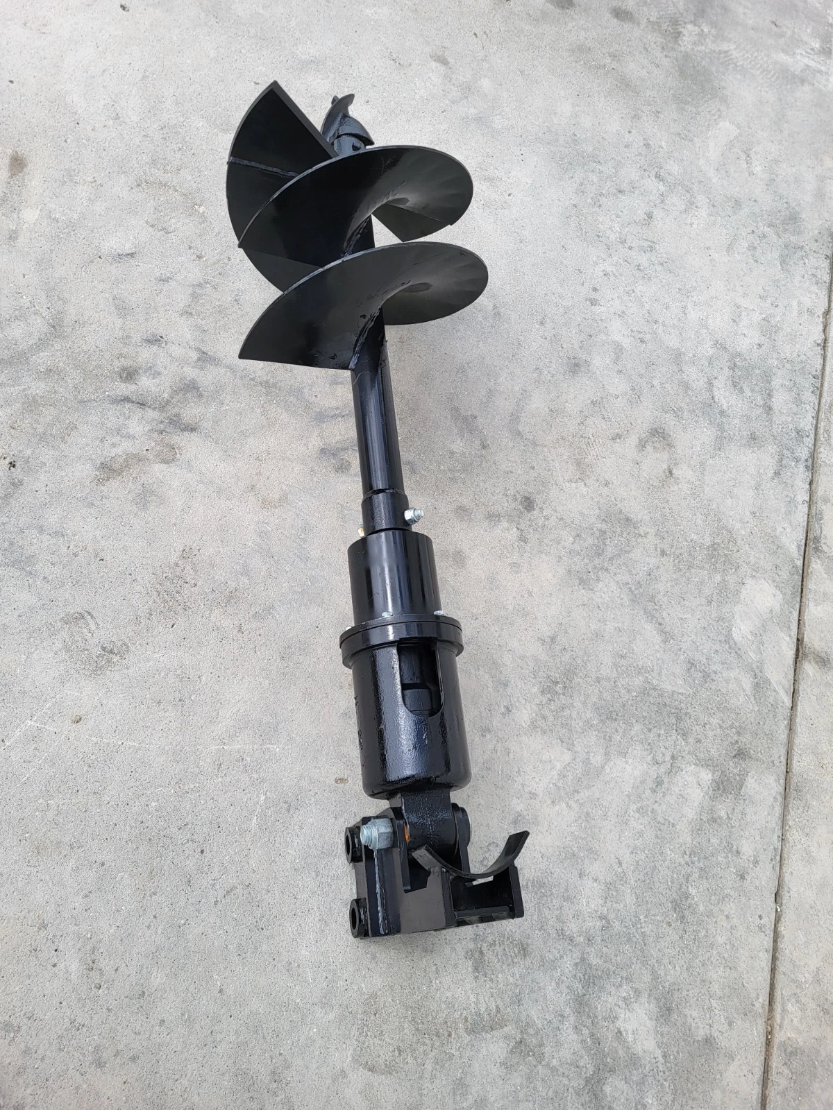 Hydraulic auger with the flighted bit uppermost, drive housing and twin-lug mounting bracket below