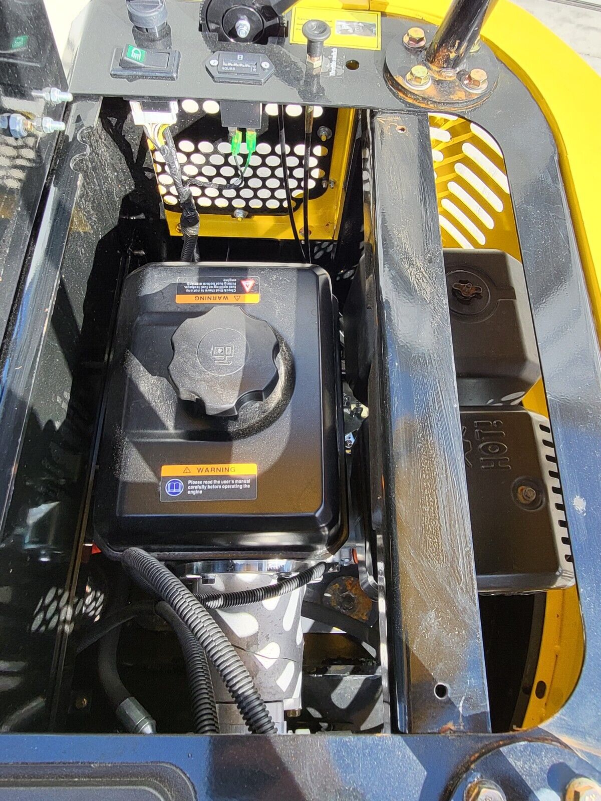 AGT QH12R engine bay: fuel tank with screw cap and warning decals beside the HOT muffler shield