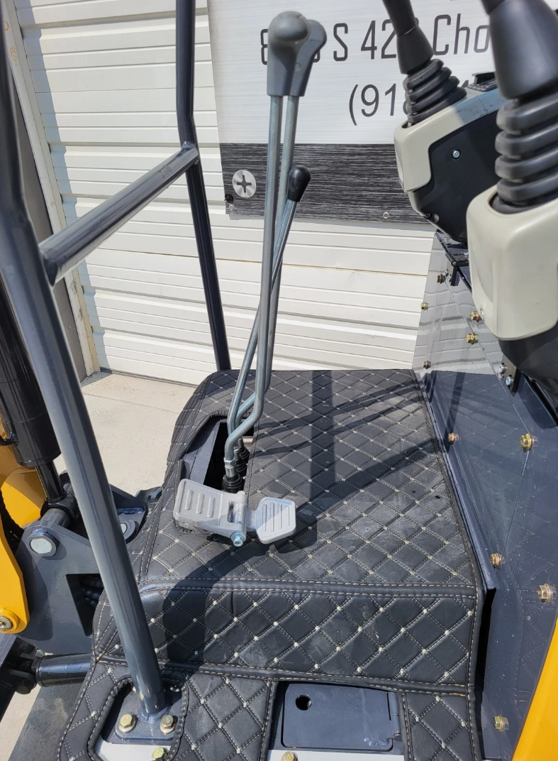 IRE18P travel levers, foot pedals and quilted floor mat beside the joystick console