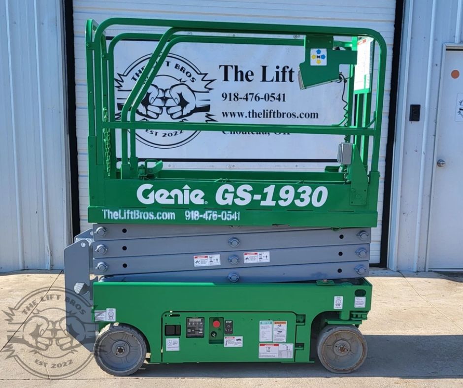 Green Genie GS-1930 scissor lift, platform lowered with guardrails up and the control box on the rail