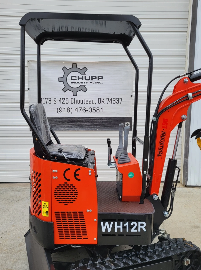 Orange WH12R mini excavator operator station with joystick controls, wrapped seat and black canopy