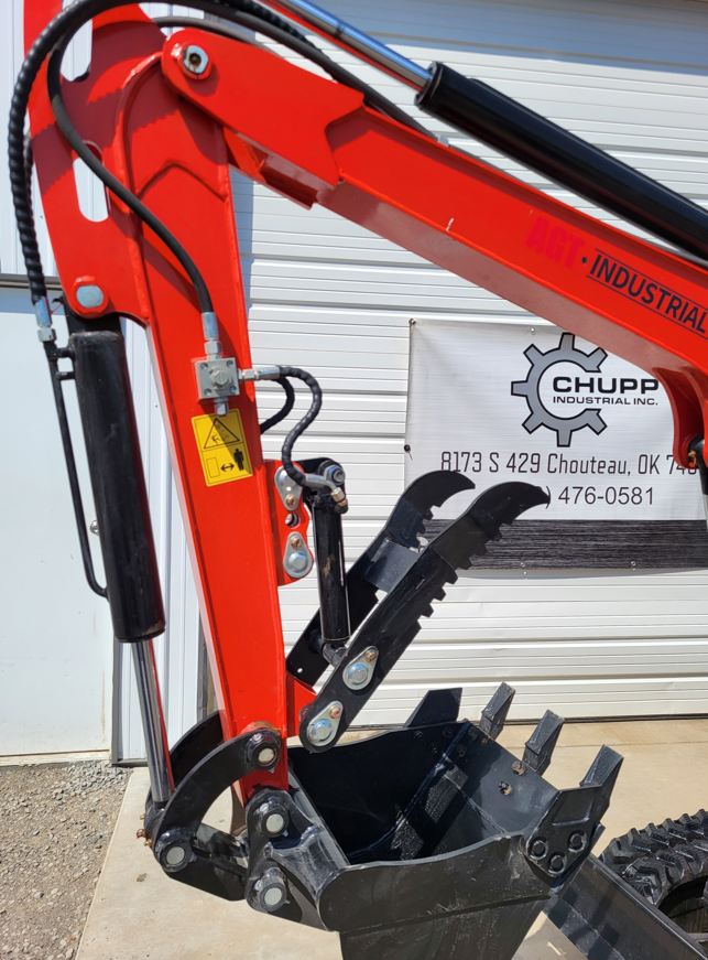 Mini excavator boom and arm in red, hydraulic thumb closed over a toothed digging bucket