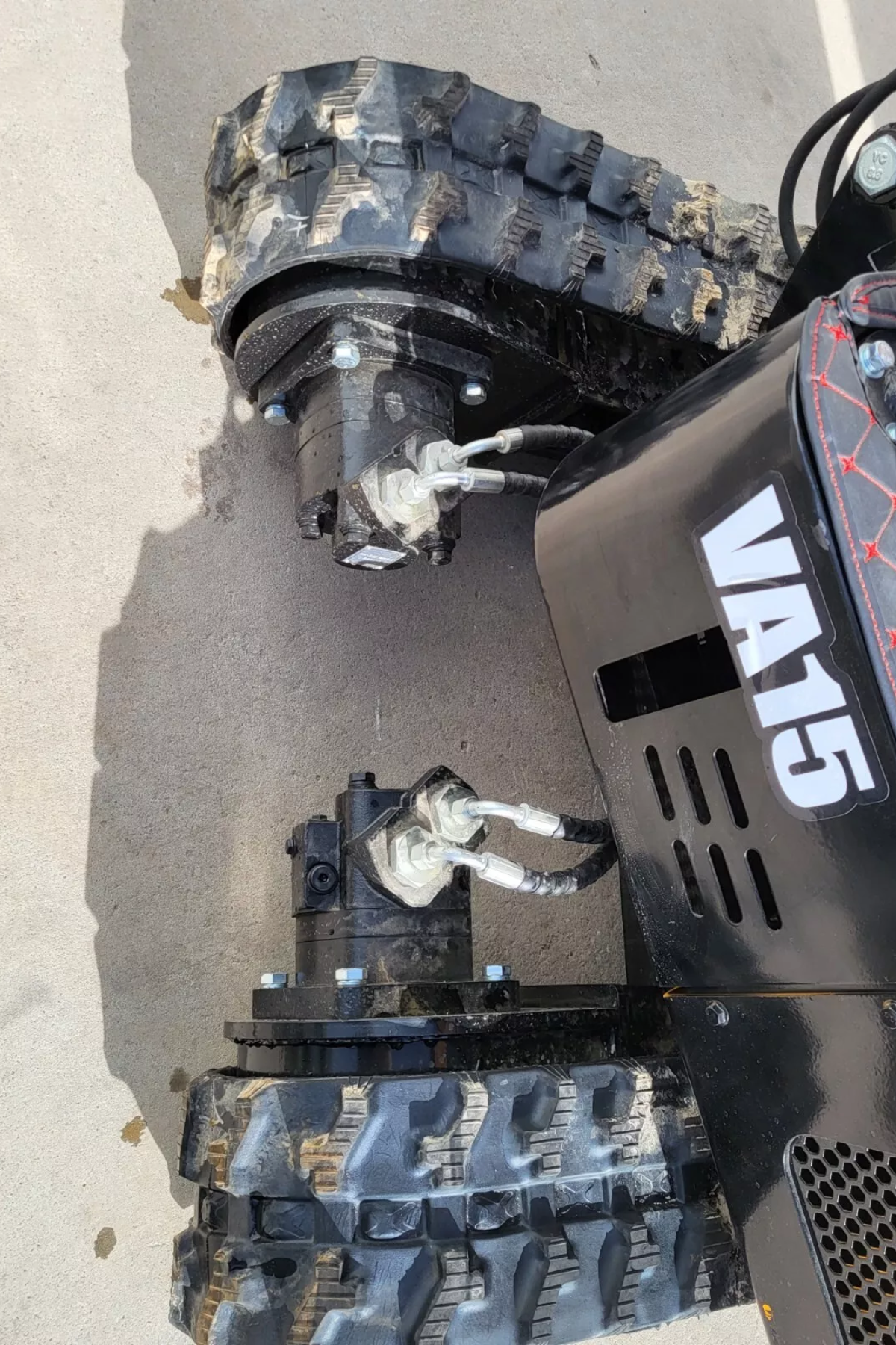 MIVA VA15 rubber tracks with the hydraulic drive motors and their hoses at the sprocket ends