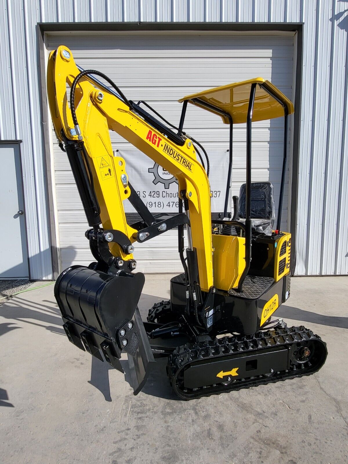 AGT QH12R mini excavator with curled boom and toothed bucket, yellow canopy and backfill blade