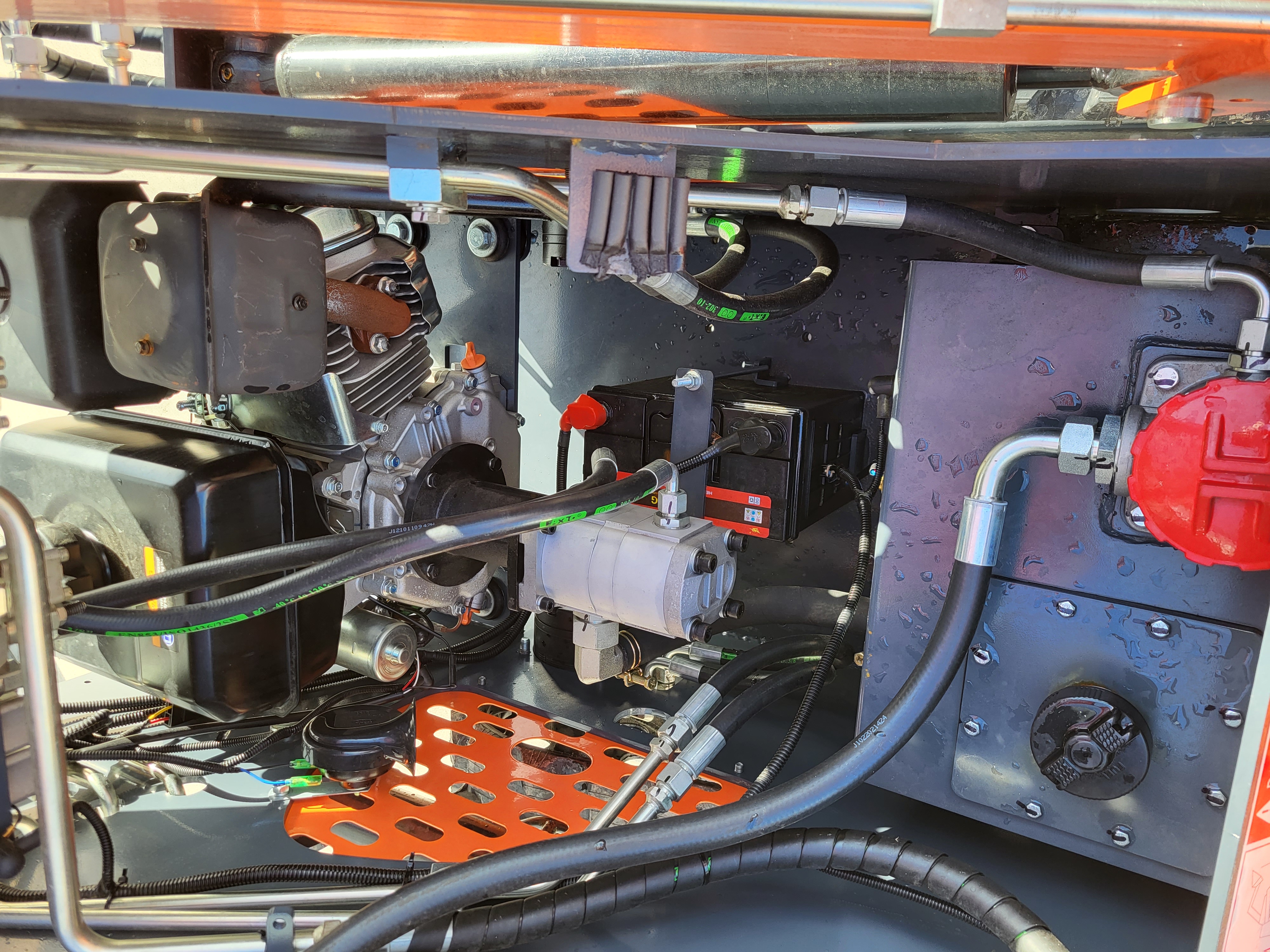 AGT YSRT14 engine bay with the gasoline engine, battery, silver hydraulic gear pump and red fuel cap