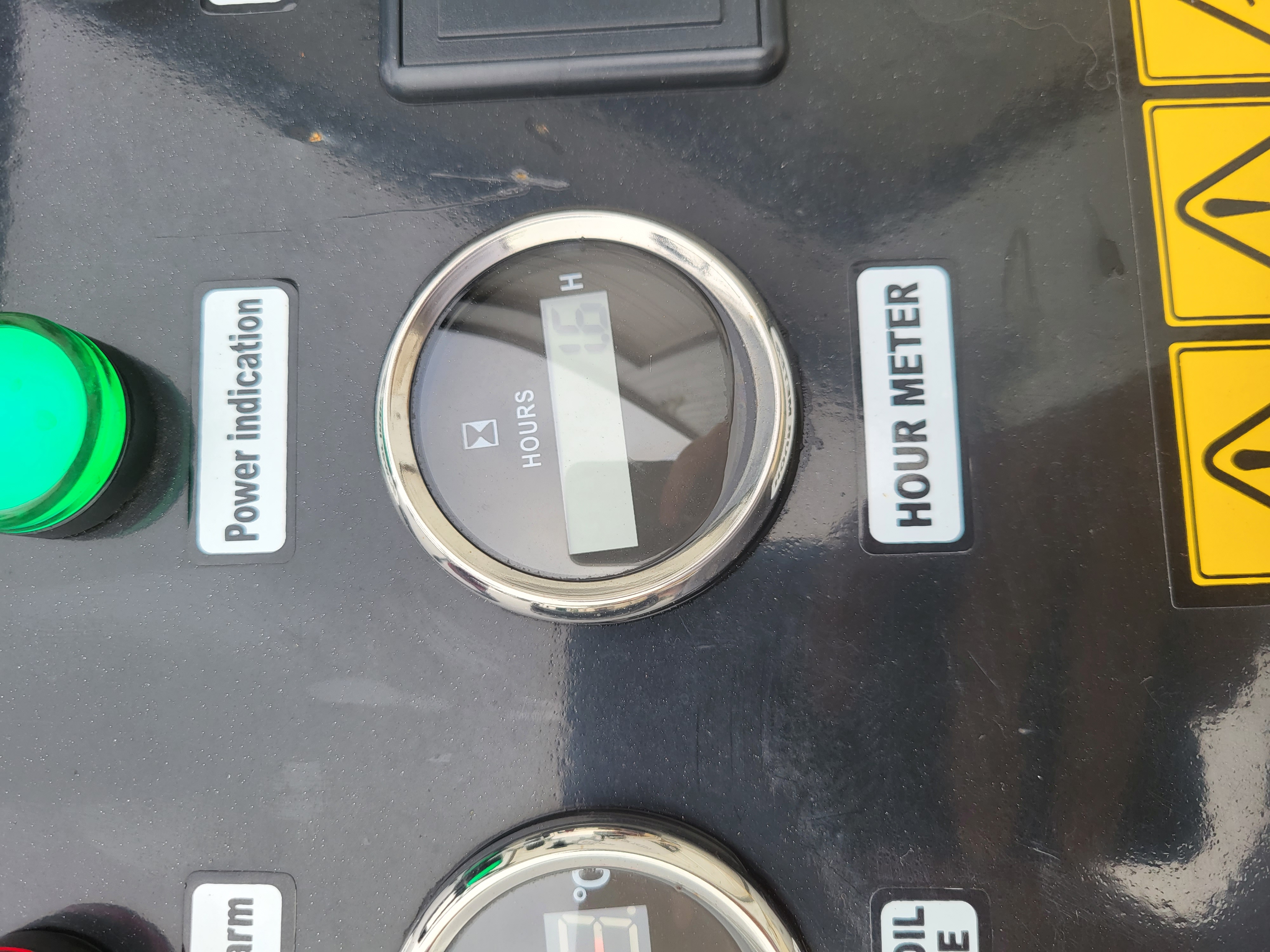 KRT23 control panel: chrome-bezel digital hour meter and the green power indication lamp