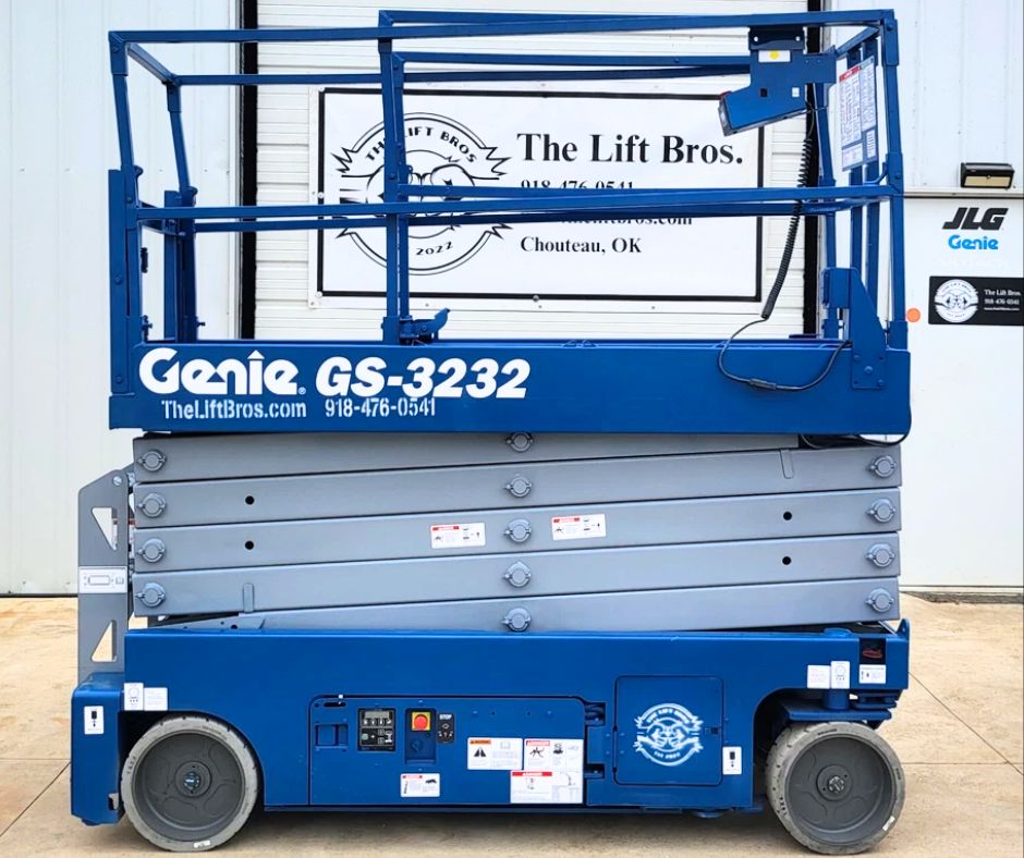 Blue Genie GS-3232 electric scissor lift with platform lowered, control box on the rail and solid tires