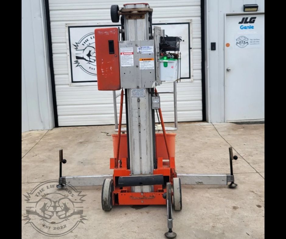 Orange push-around vertical mast lift with aluminum telescoping mast, outriggers extended and swivel casters