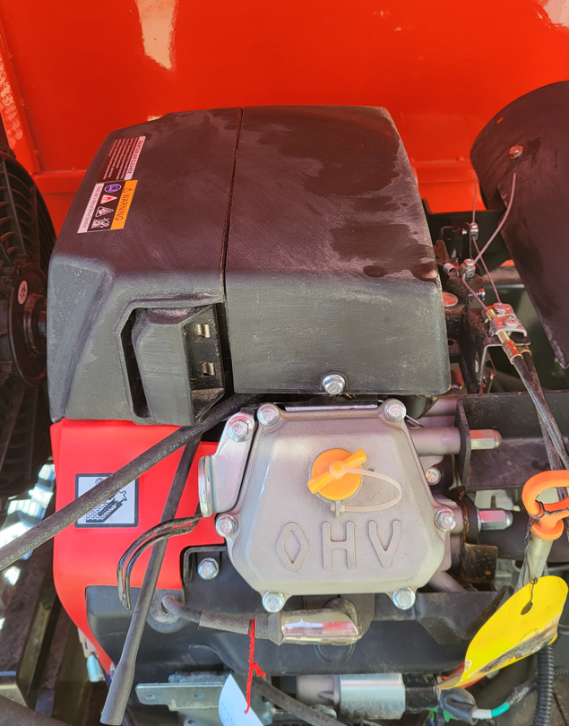 Mini excavator engine bay: air-cooled OHV engine with black air-filter cover, throttle linkage and warning decals