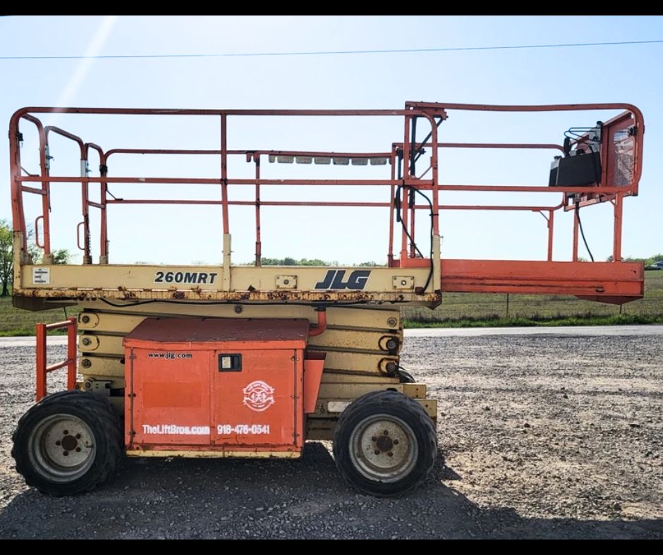 JLG 260MRT rough terrain scissor lift, orange and tan, lowered platform with slide-out deck extension and guardrails