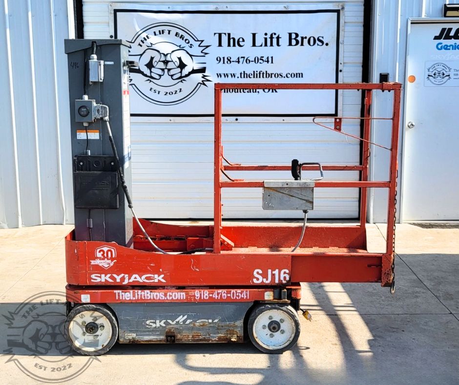 Skyjack SJ16 vertical mast lift in red, gray mast at the rear, guardrailed platform, control box on the mast