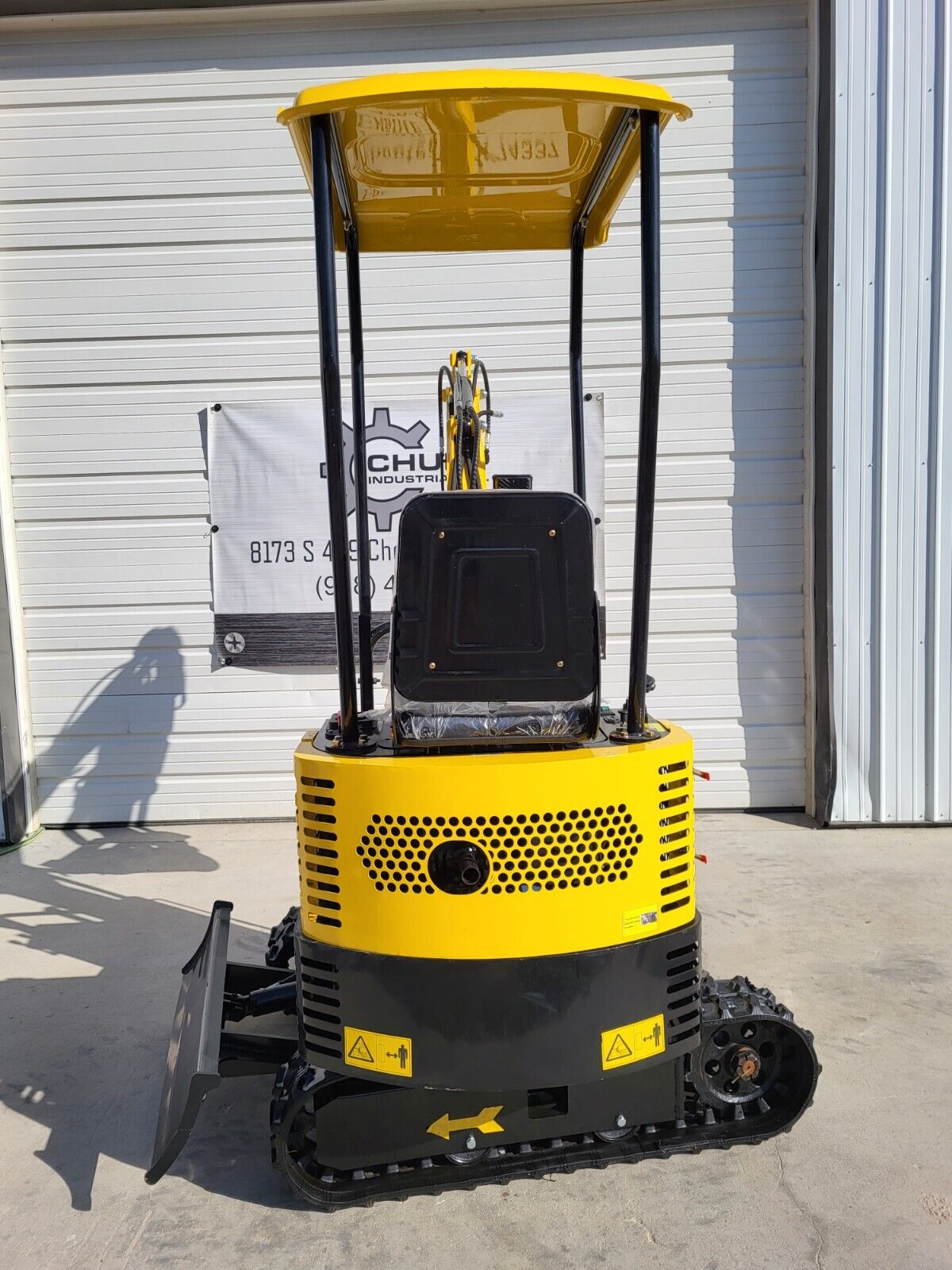 AGT QH12R vented engine housing, canopy and seat above the rubber tracks and backfill blade