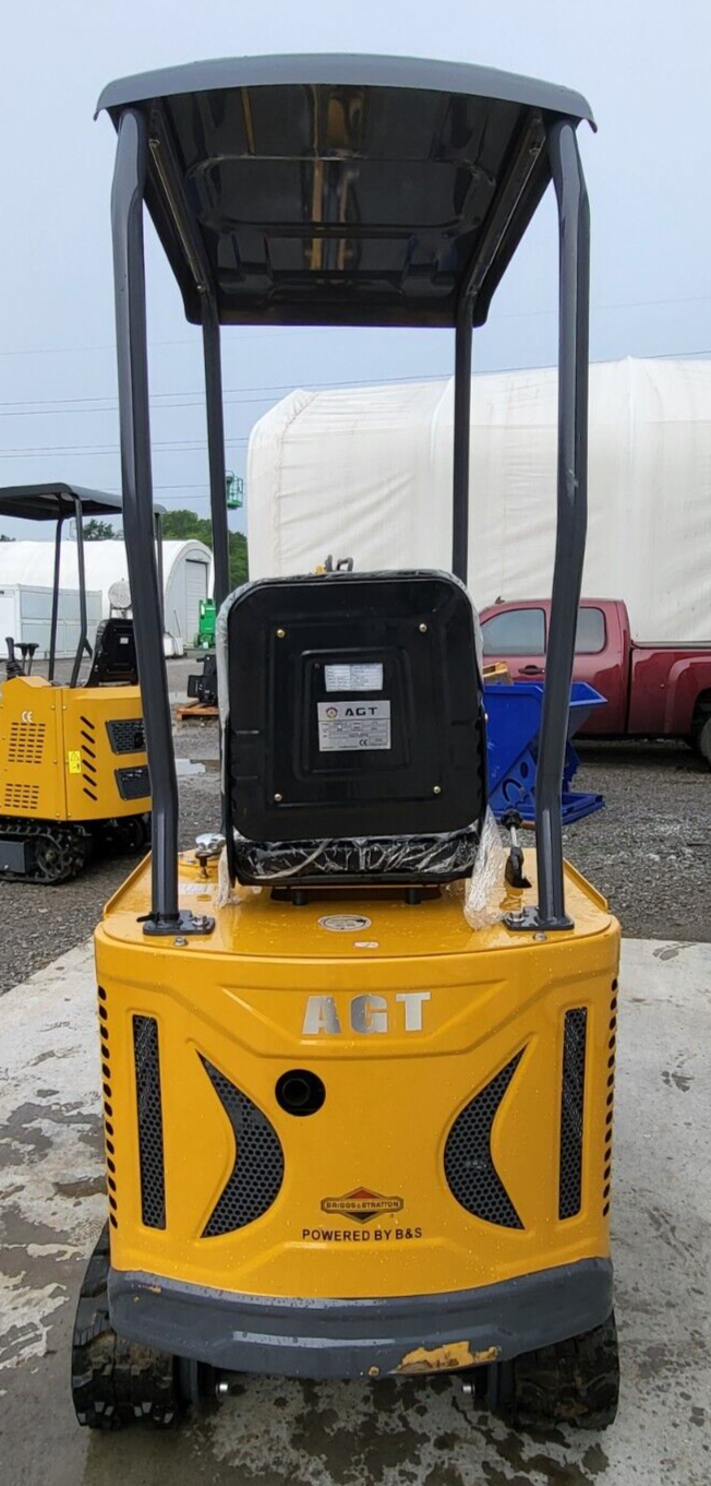 AGT DM12-C rear: yellow engine cover with the AGT badge and Powered by B&S decal, vents, canopy over the wrapped seat
