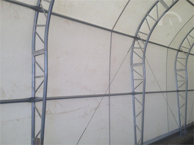 Dual truss galvanized steel arches and purlins inside the white PVC fabric building cover