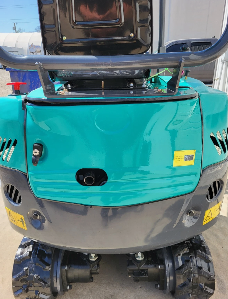 QK16R mini excavator from the rear, engine hood raised over the counterweight and rubber tracks