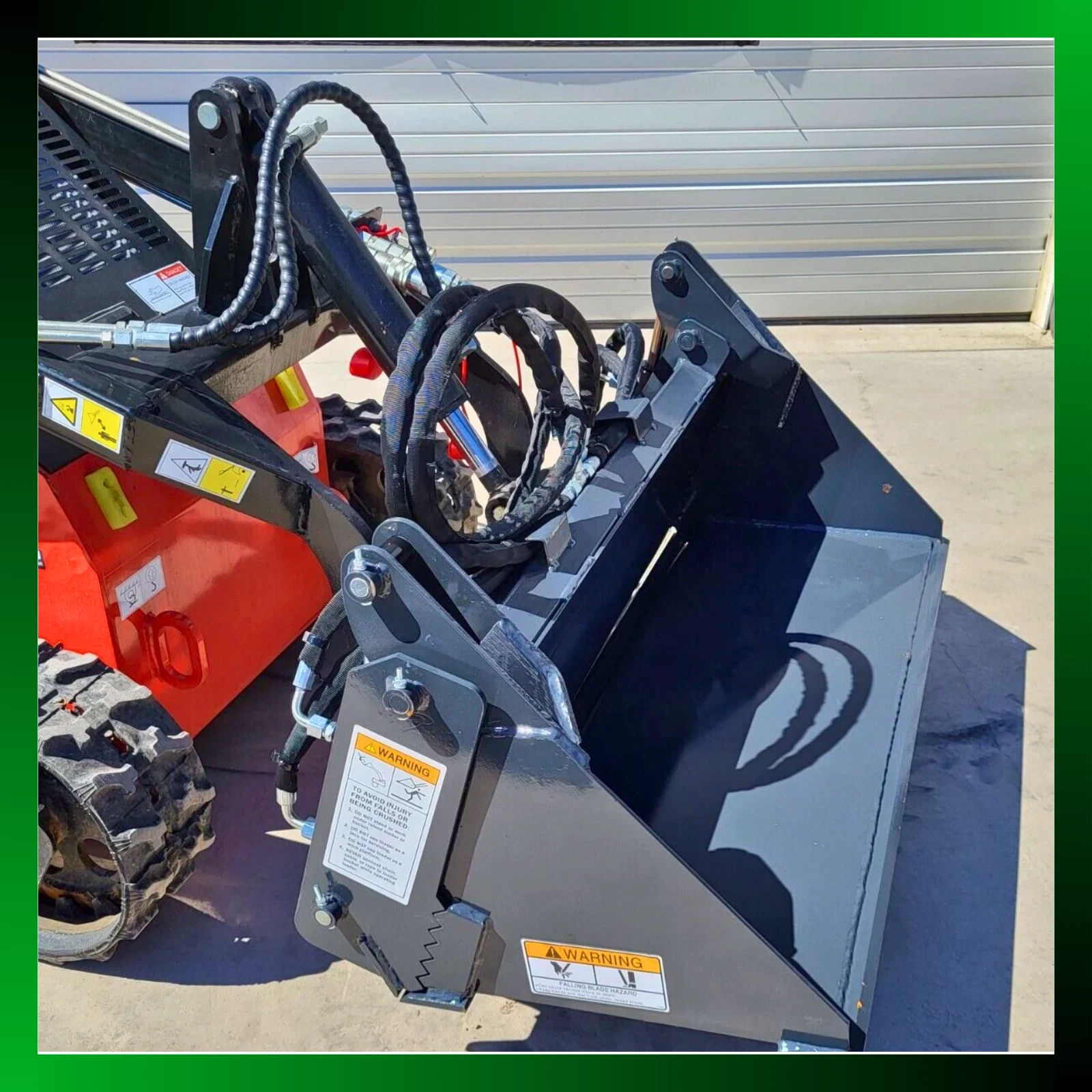 Gray 4-in-1 bucket on an orange tracked mini skid steer, coiled hoses to the clamp cylinders, green border