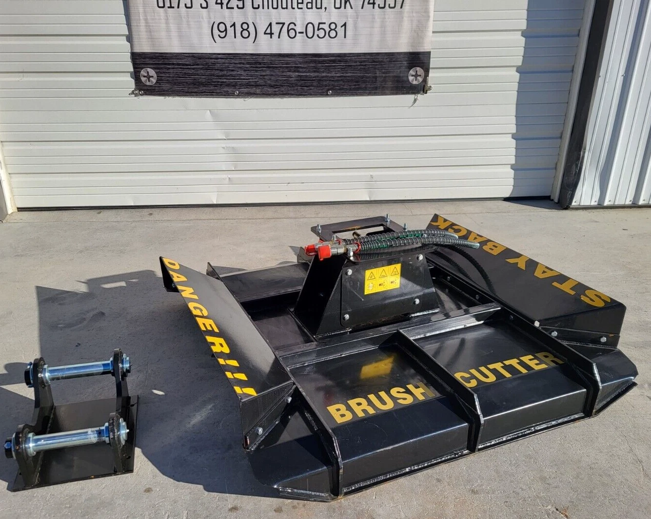 Brush cutter deck, yellow DANGER and BRUSH CUTTER lettering, twin-pin mounting bracket set to the side