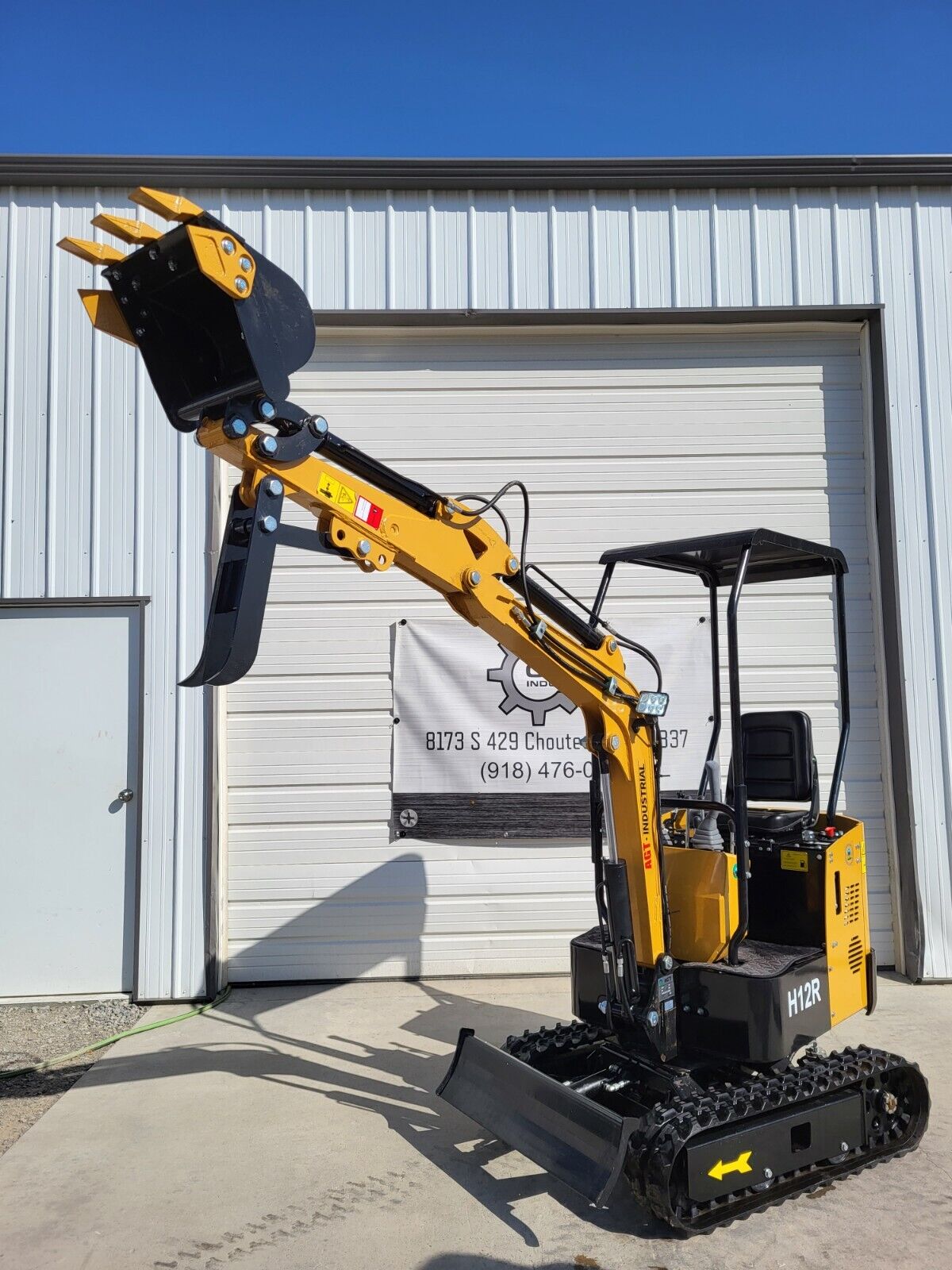 AGT H12R mini excavator with the boom extended, toothed digging bucket, fixed thumb and backfill blade