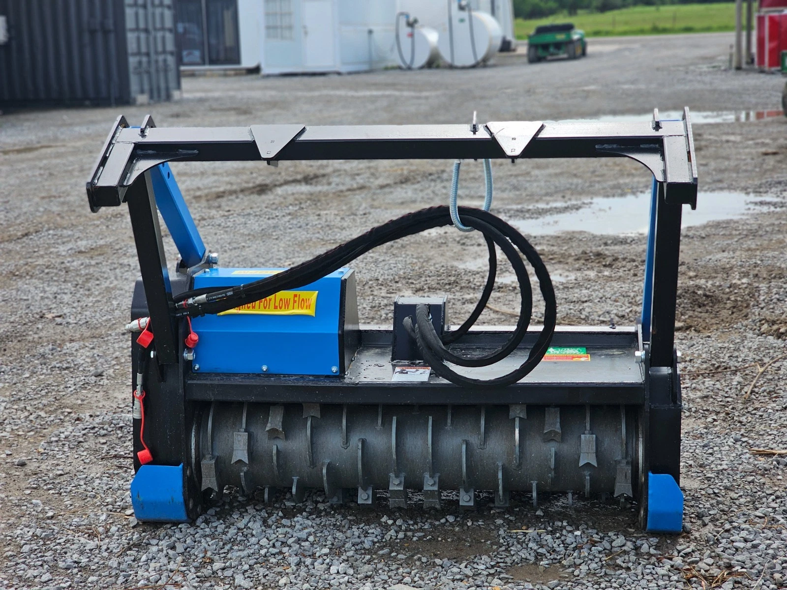 Raytree drum mulcher in blue and black, Designed For Low Flow decal, toothed drum and hoses