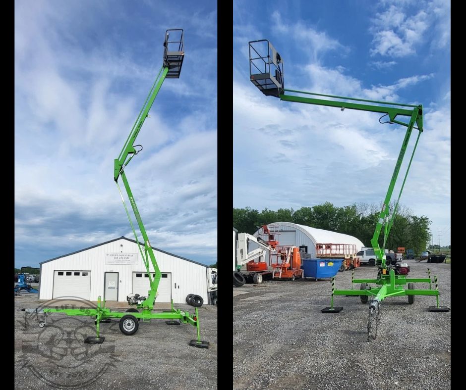 Green towable boom lift with the articulating boom raised and the work platform elevated
