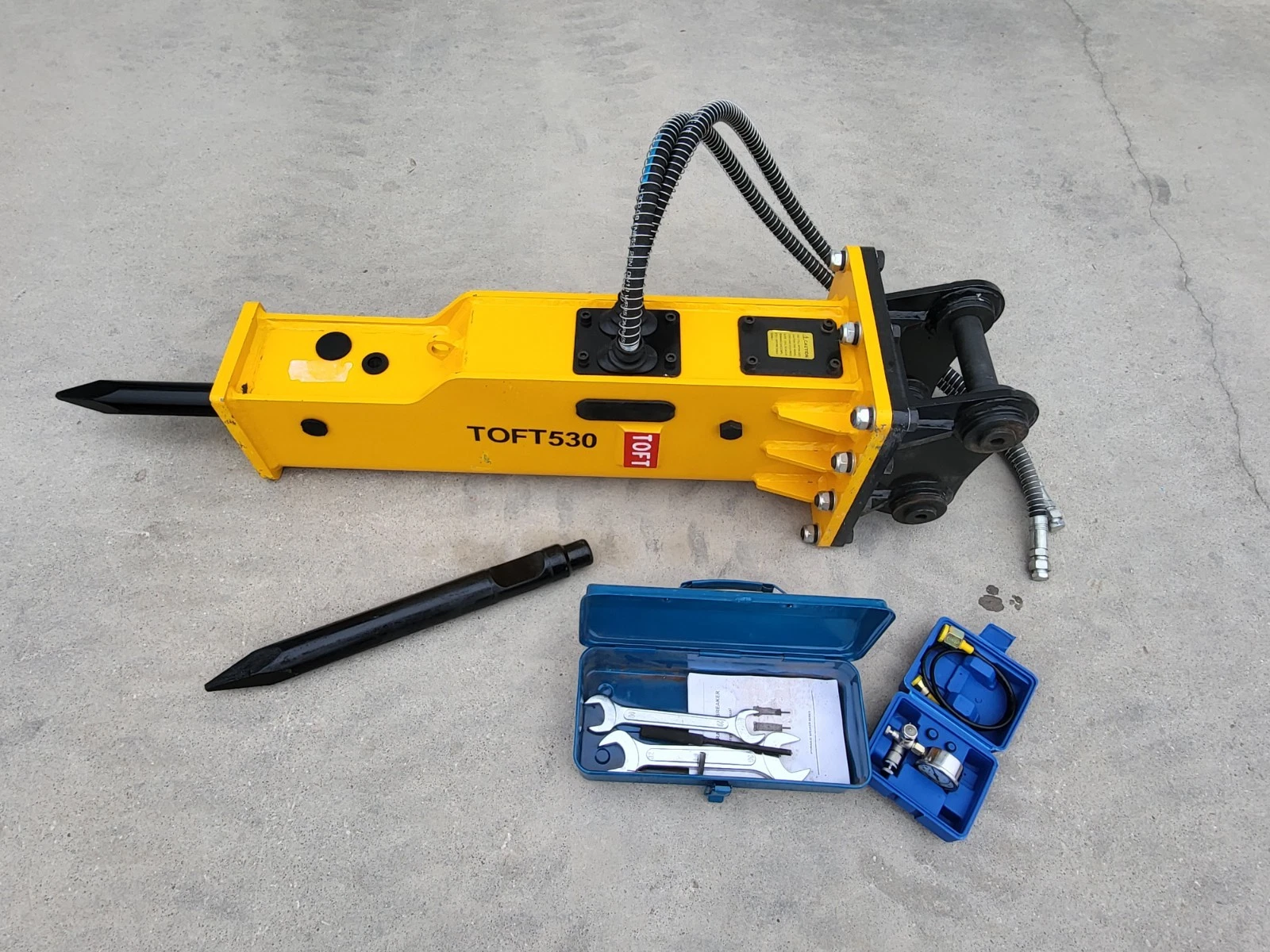 TOFT530 yellow hydraulic breaker with moil point fitted, spare chisel, wrench box and blue charge kit