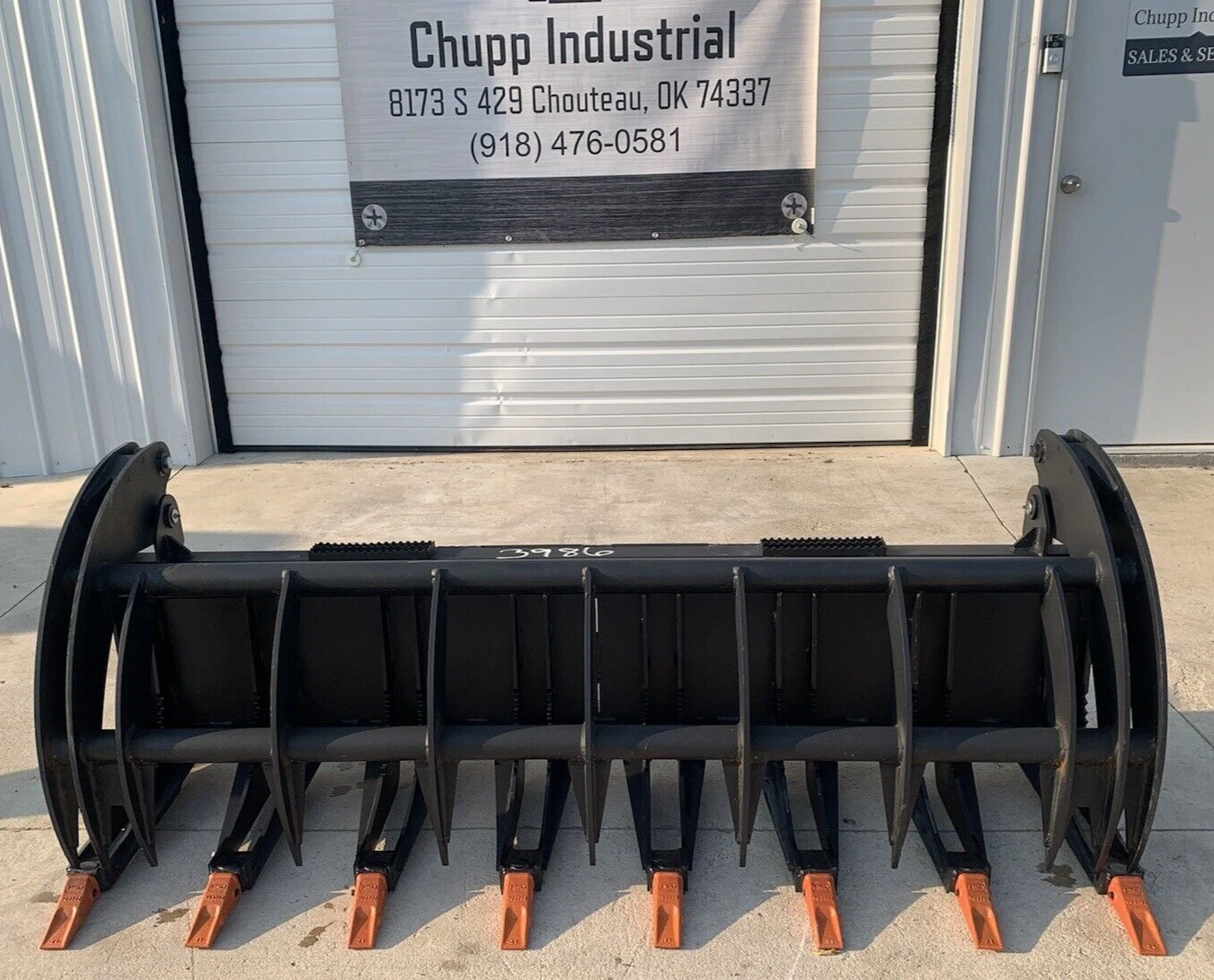 Black 78-inch rock grapple bucket, eight orange-tipped tines, grapple arms raised open