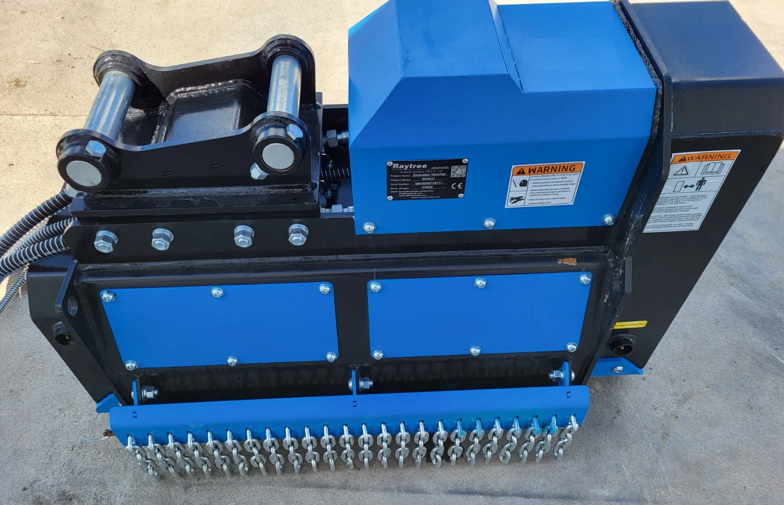 Blue Raytree REDM32 mulcher from above: pin-on mount, data plate, warning decals and chain guard