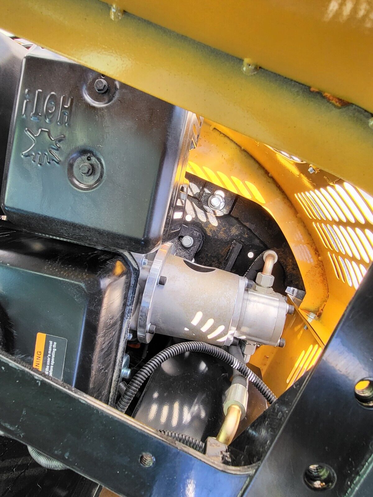 AGT H13R engine bay: starter motor and wiring beside the HOT-stamped muffler shield and fuel tank