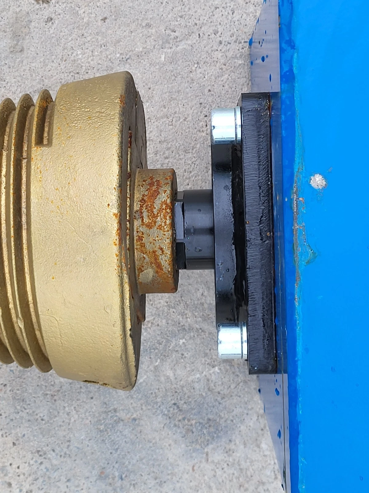 Two hydraulic quick-connect couplers with red dust caps on the log splitter's supply hoses
