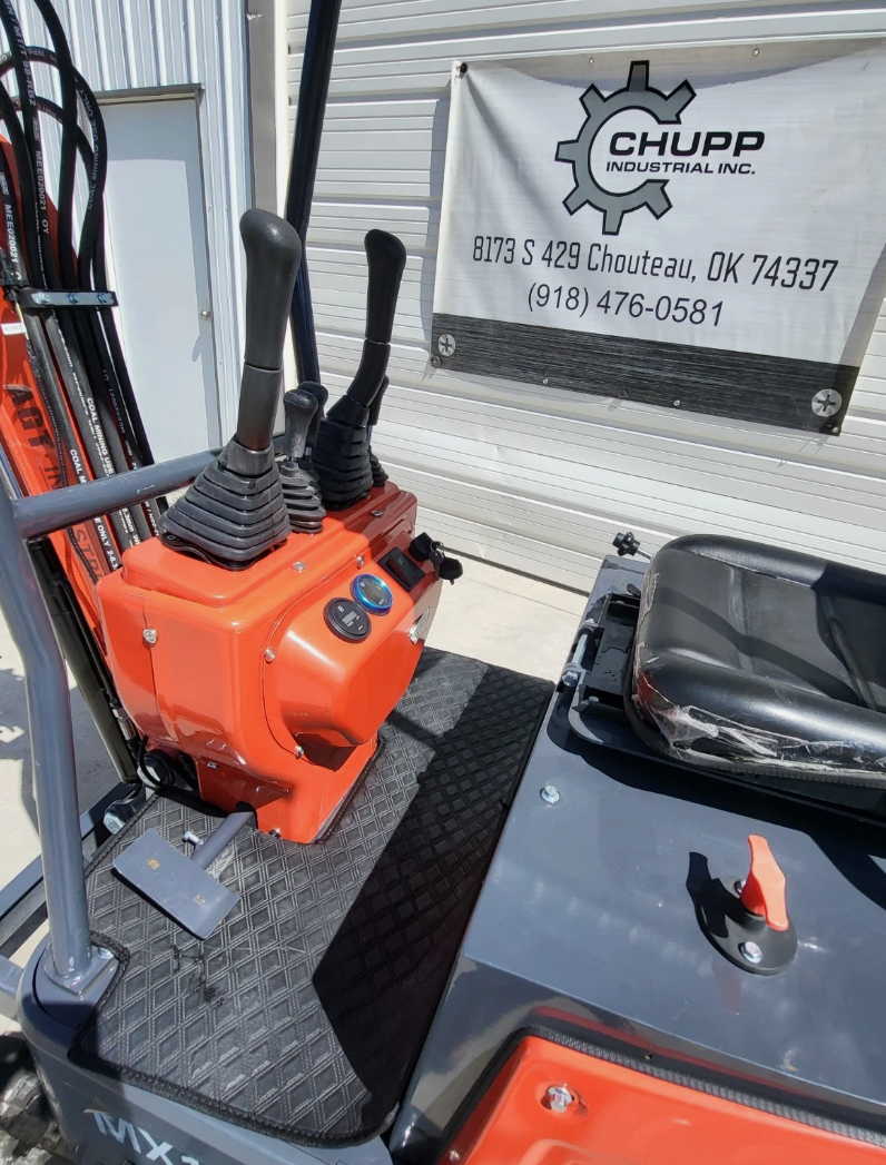MX15R mini excavator controls: twin joysticks, ignition dash, rubber floor mat and operator seat