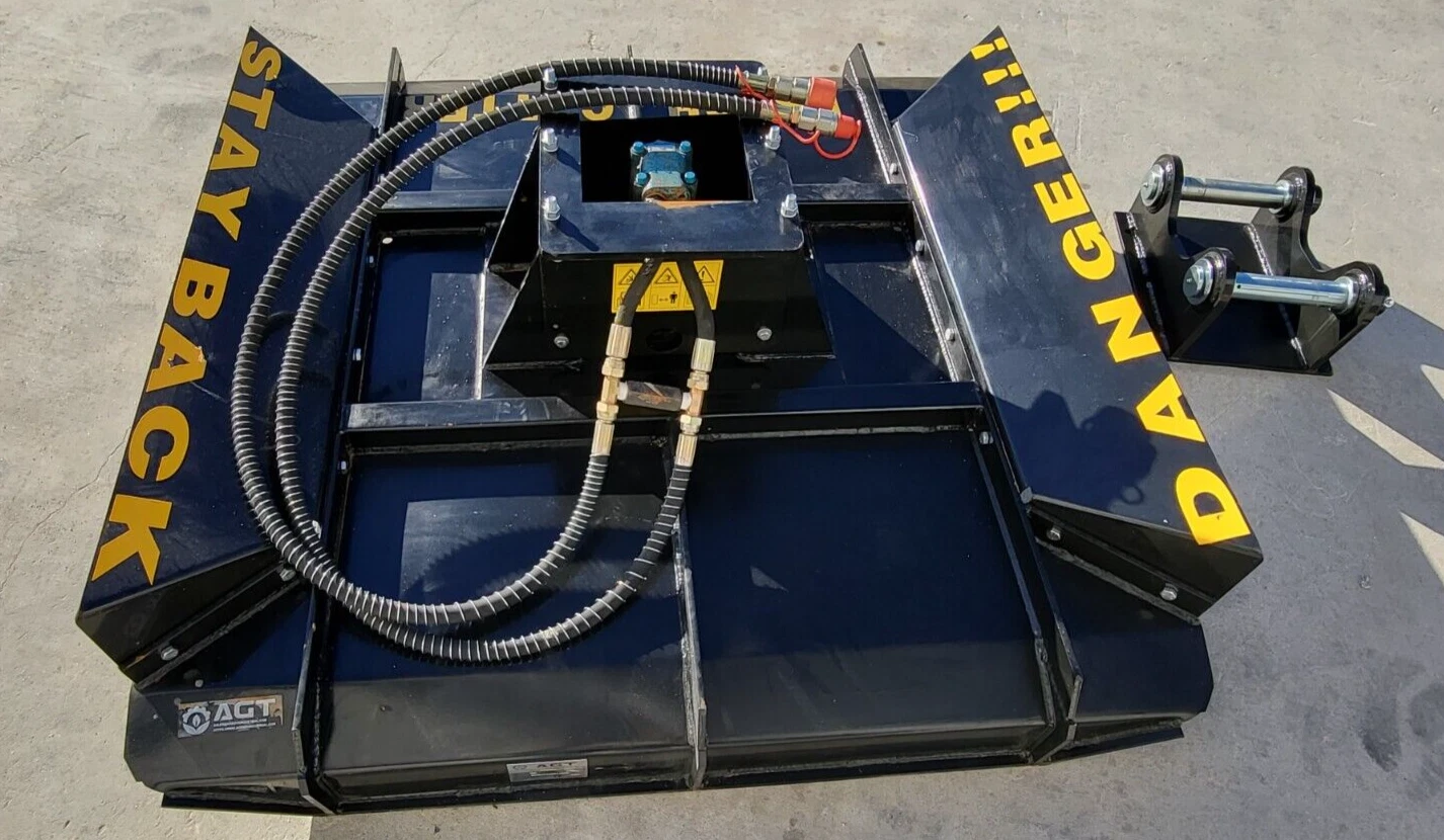 AGT brush cutter deck from above, hoses and safety lettering, twin-pin mounting bracket set alongside