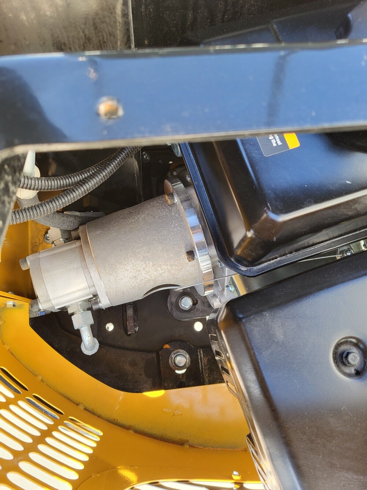 Electric starter motor and wiring on the AGT H12R mini excavator engine, under the open engine cover
