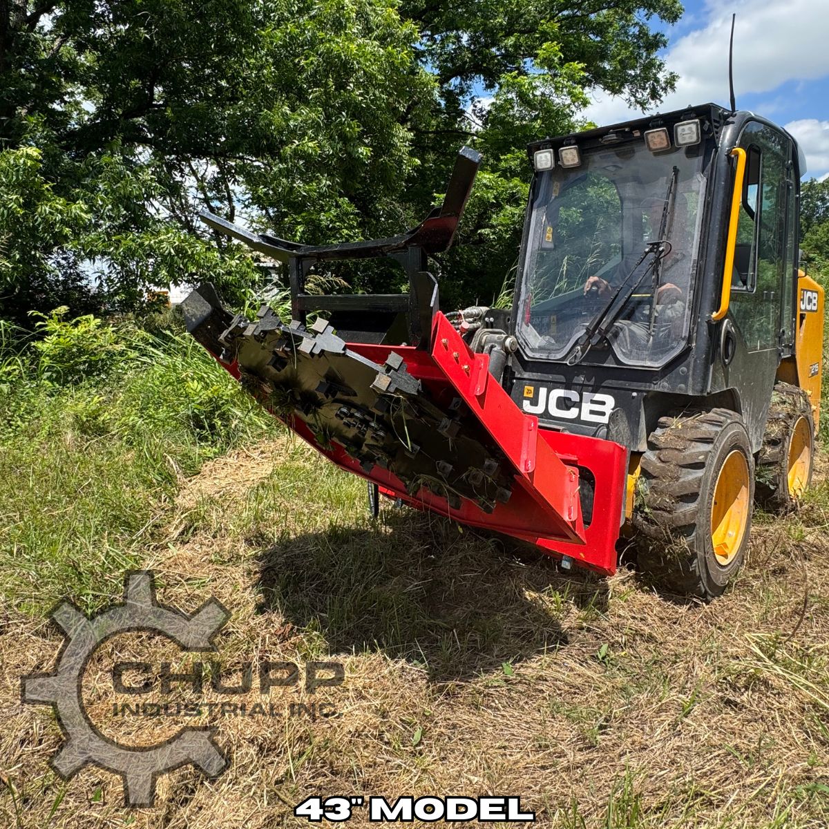 Red disc mulcher tilted up on a JCB skid steer, cutting disc and bolt-on teeth packed with cut vegetation