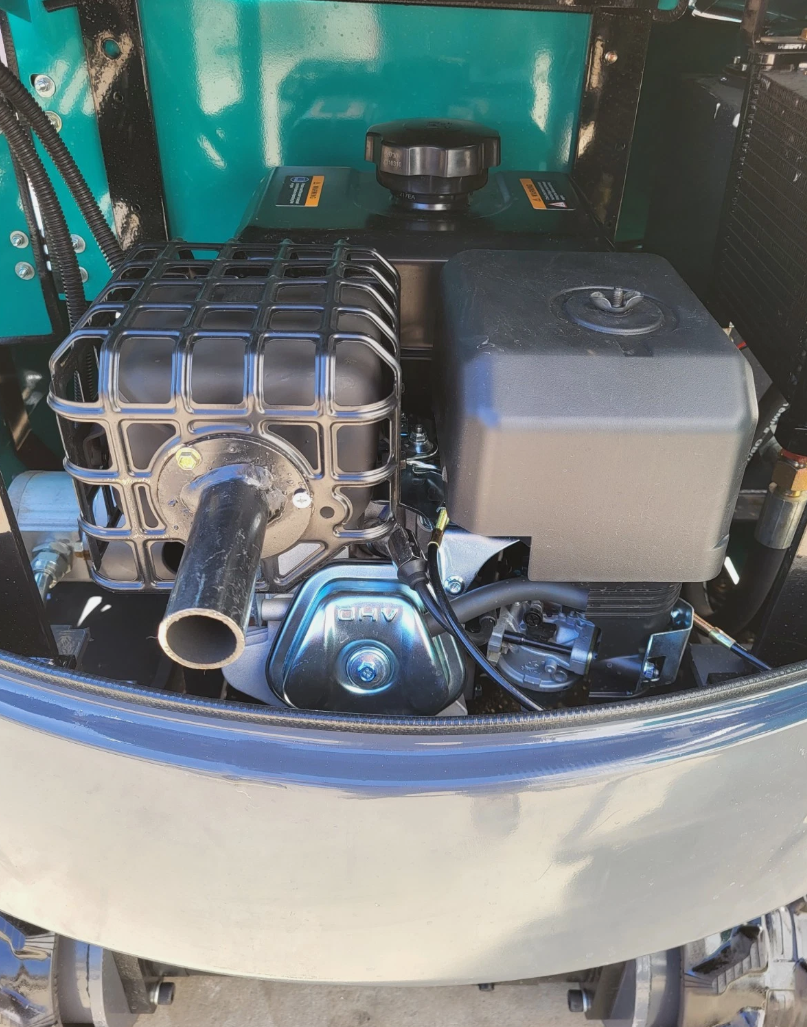 QK16R mini excavator engine bay: air-cooled engine with guarded muffler, air cleaner and fuel tank
