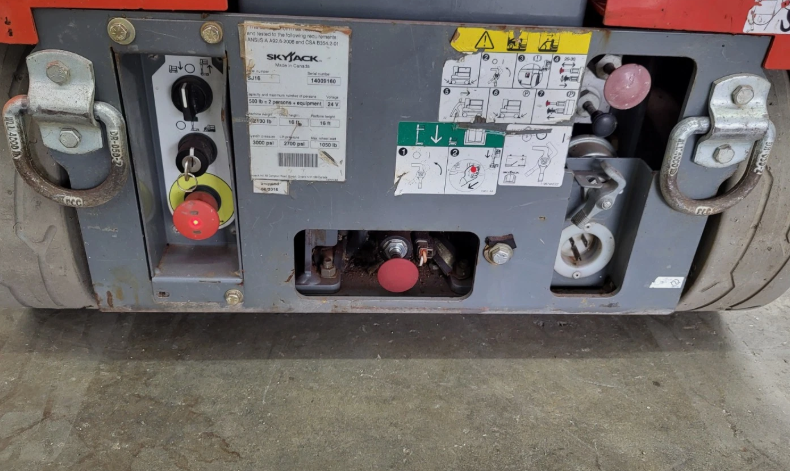 Skyjack SJ16 ground controls: key switch, red emergency-stop, operation decals and rating plate