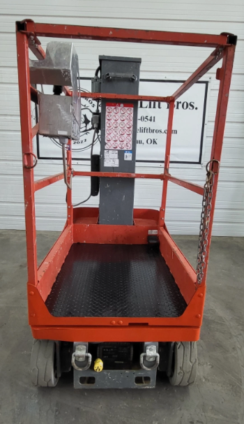 Skyjack SJ16 platform from the rear: orange guardrails, diamond-plate deck and control box