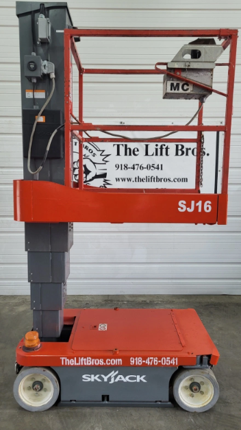 Orange Skyjack SJ16 vertical mast lift, side profile, mast stowed over the drive base