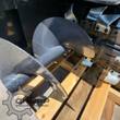 Wolverine trencher spoil auger: black steel flighting that clears dirt from the trench, chain teeth behind it