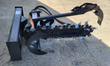 JCT hydraulic trencher: digging chain with teeth, auger point, and crumber arm at the quick-attach mount