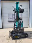 Teal AGT MH12RX mini excavator, boom raised with digging bucket and thumb, backfill blade and rubber tracks