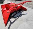 Red disc mulcher at an angle: steel push frame, hydraulic hoses and the toothed black cutting disc beneath