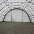 Interior of the fabric building, arch ceiling and back wall with a door