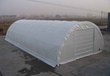 30x65x15 white PVC fabric storage building, arched steel frame, end wall with a door