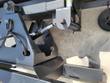 Back of the push blade: chrome hydraulic cylinder, pinned pivot bracket and coil trip spring on the quick-attach frame