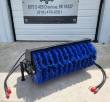 Angle broom on its park stand, full-width blue bristle roller and two hoses with red-capped couplers