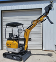 ME20 mini excavator with the boom raised and the hydraulic thumb open above the bucket, front blade lowered