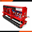 Red AGT no till seed drill: seed hopper, blue seed tubes to the row openers, toothed packer roller wheels