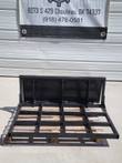 Black steel land leveler on a pallet: flat open grid leveling frame with an upright moldboard blade